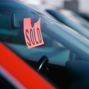 red car at auto auction with sold tag