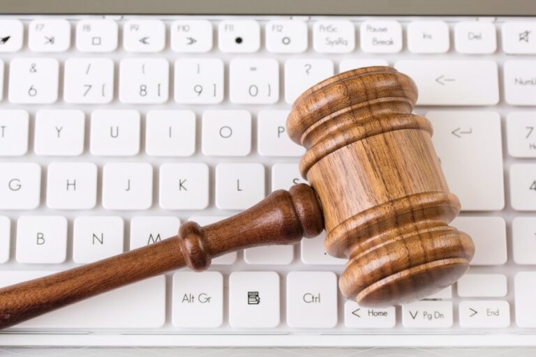 Auctioneer's gavel resting on a computer keyboard representing online auctions
