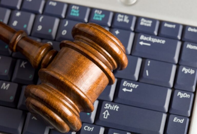 Online auction concept with auction gavel placed on a computer keyboard